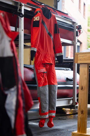 An Immersion Research search and rescue dry suit hanging up at a task force HQ.